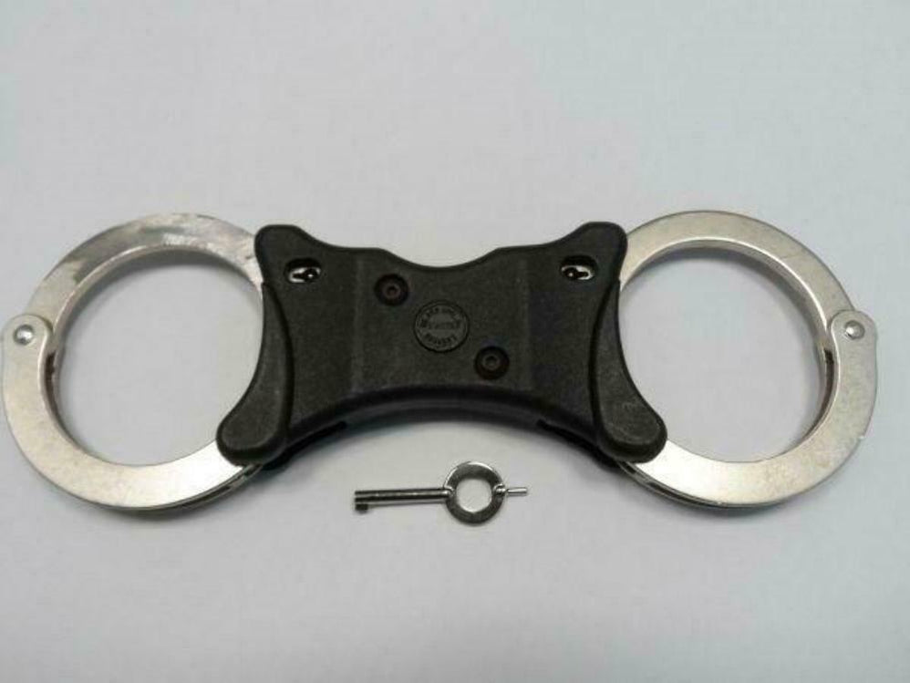 An Offender Standing in Handcuffs Near the Car. Concept of Arrest the ... Handcuffs near me